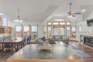 a living room with a table and a couch at Sea Spray in Waves