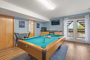 a living room with a pool table in it at Sea Spray in Waves