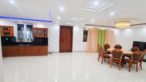 a kitchen and dining room with a table and chairs at Hà Chi Villla Hà Giang in Ha Giang