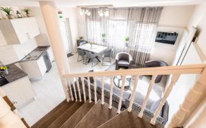 a view of a living room and kitchen from the top floor of a house at Óvár Apartman in Mosonmagyaróvár