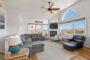 a living room with a couch and chairs and a ceiling fan at HIWA03: Lands End in Waves