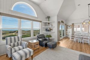 a living room with two chairs and a table at HIWA03: Lands End in Waves