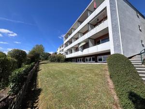 a large building with a lawn in front of it at MeLou FeWo NaturQuartier Wellness in Bad Lauterberg