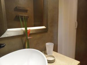 a vase with a flower in it sitting on a table at Travelers Nest in St Lucia