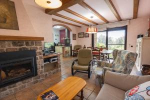 a living room with a fireplace and a table at Catalunya Casas Peaceful Perfection , only 30km from Barcelona! in Vacarisas