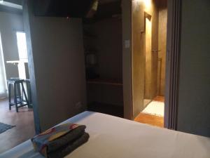 a room with a bed with a mirror and a hallway at Travelers Nest in St Lucia