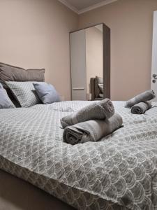 a bedroom with a bed with towels on it at Apartman Mikulic 2 in Subotica
