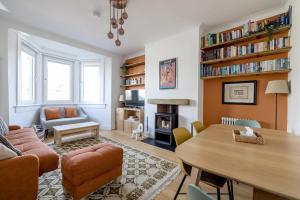 a living room with a table and a dining room at Barnton Grove Getaway in Edinburgh