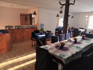 a dining room with a table and chairs in a room at Blu EDGE BEACH RESORT in Katuneriya