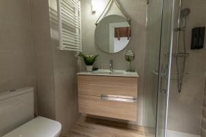 a bathroom with a toilet and a sink and a mirror at La casina de la alberca in La Alberca +14 photos