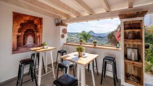 a room with a table and chairs and a window at Finca Gran Cerros in Alora