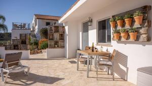 a patio with a table and chairs and a building at Finca Gran Cerros in Alora +29 photos