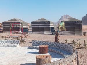 a group of three domes with a couch in the desert at Wadi rum camp teem in Wadi Rum +32 photos