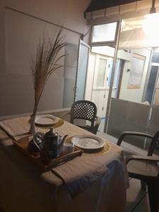 a table with two plates and a vase on it at Villa Nature Glee in Dodanduwa