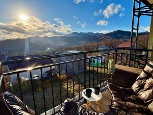a balcony with a view of the mountains at Olive retreat Sapporo 札幌市南区 一軒家の1フロア貸切 5名まで 2ベッドルーム 無料駐車場 登山 スキー場への好アクセス in Sapporo