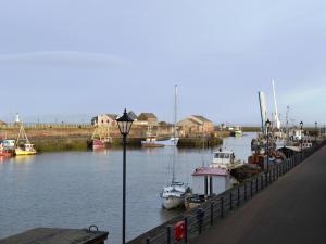 a group of boats are docked in a marina at Ritson Wharf in Maryport