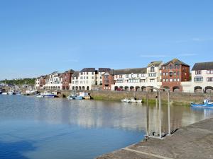 a view of a river with buildings and boats at Ritson Wharf in Maryport