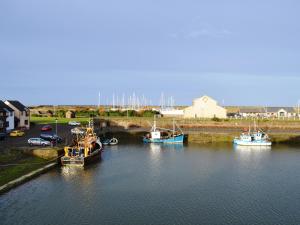 a group of boats are docked in a harbor at Ritson Wharf in Maryport