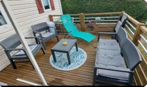 two chairs and a table on a deck at Mobil home in Biscarrosse