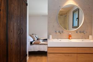 a bathroom with a sink and a mirror at Villa CAMILLE in Ersa +38 photos