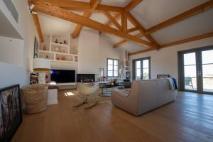 a large living room with a couch and a tv at Villa CAMILLE in Ersa
