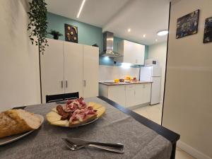 a plate of food on a table in a kitchen at Estudios Céntricos 65 in Santander +21 photos