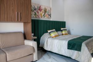 a bedroom with a bed and a chair and a couch at Augustea Travel Rooms in Frignano