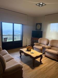 a living room with two couches and a coffee table at Casa Hipólito in A Estrada