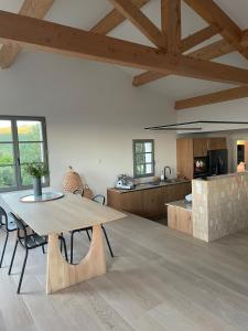a large kitchen with a wooden table in a room at Villa CAMILLE in Ersa