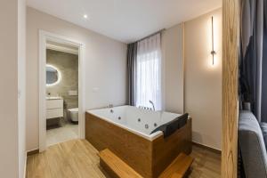 a bathroom with a large bath tub in a room at Sea La Vie Suites in Golem +100 photos