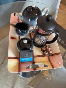 a tray with a tea kettle and other items on a table at Anniston Farm Cottages in Inverbervie