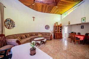a living room with a couch and a cross on the wall at Nazareth Guest House in Kigali