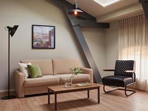a living room with a couch and a chair at YAYS Amsterdam Maritime by Numa in Amsterdam