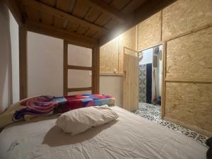 a bedroom with a bed with a ladder on it at The Trizit in Taghazout