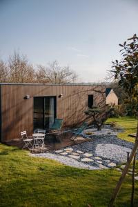 a house with a deck and two chairs on it at Chez Lilie in Le Sel