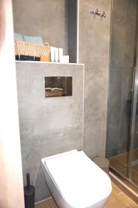 a bathroom with a toilet and a shower at The Little House Lamia - Fresh Central Apartment in Lamía