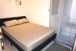a bed with two pillows on it in a room at The Little House Lamia - Fresh Central Apartment in Lamía
