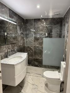 a bathroom with a sink and a toilet at 2 Bedroom, Sea Side Retreat Saronida in Saronida +15 photos