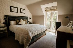 a bedroom with a large bed and a window at The Lion Inn in Chelmsford
