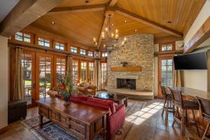 a living room with a couch and a fireplace at Villa Merion at PGA West | Grand Tuscan Estate in La Quinta
