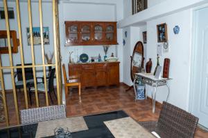 a living room with a wooden cabinet and a table at Preloune Residences SA in Cap-Haïtien