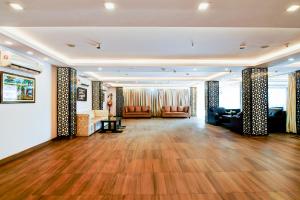 a large lobby with couches and a fireplace at Hotel Eco Park By Carlton Suites in kolkata