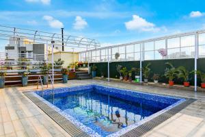 a swimming pool on the roof of a building at Hotel Eco Park By Carlton Suites in kolkata