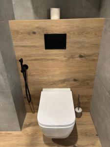 a bathroom with a white toilet in a room at Bavaro apartments 3 in Ivano-Frankivsk +6 photos