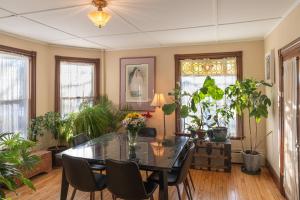 a dining room with a table and some plants at Forest City Oasis and Spa in South Portland