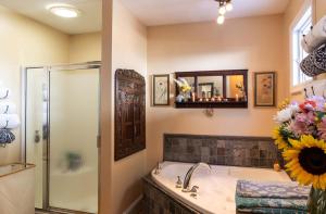 a bathroom with a tub and a shower and a mirror at Forest City Oasis and Spa in South Portland +32 photos