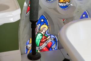 a stained glass window in a bathroom next to a toilet at Church conversion, Private garden, Parking in Cuckfield +24 photos