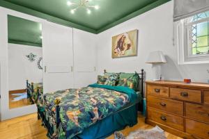 a bedroom with a bed and a wooden dresser at Church conversion, Private garden, Parking in Cuckfield