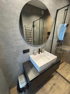 a bathroom with a sink and a mirror at Bavaro apartments 3 in Ivano-Frankivsk