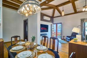 a dining room and living room with a table and chairs at SaffronStays The Devrai by the Sea in Bhogwe